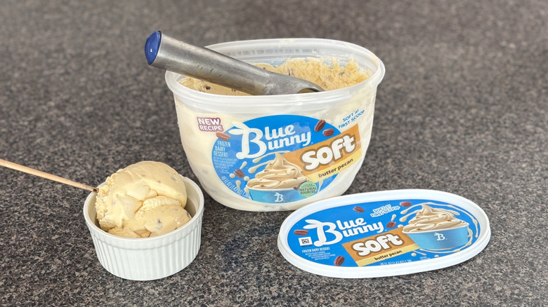 carton of ice cream with bowl of ice cream beside it
