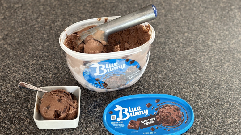 Blue Bunny chocolate brownie ice cream container with bowl and brownie bits in it