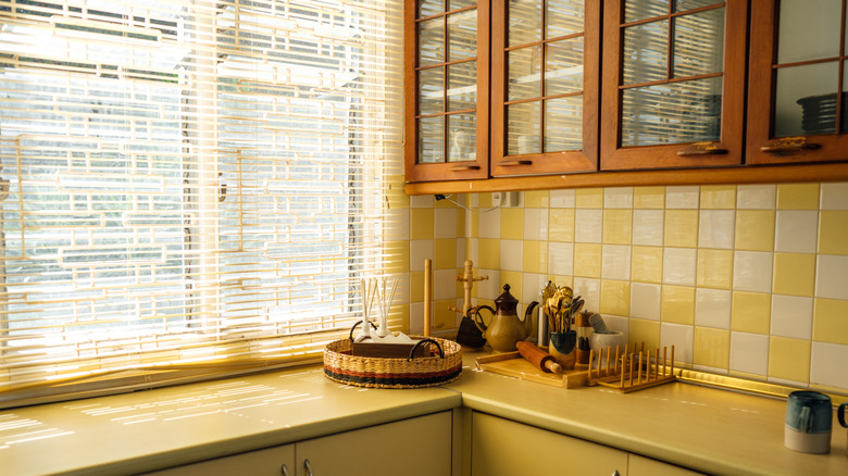 A warm, yellow kitchen with tile backsplash