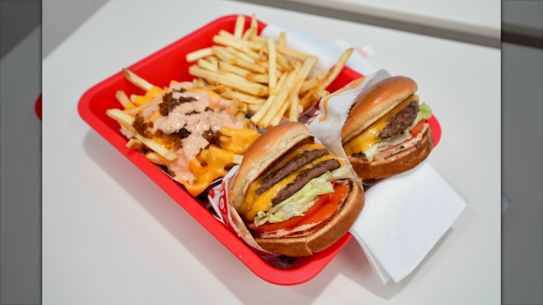 In-N-Out burger and fries on tray inside a restaurant.