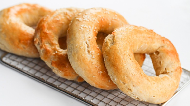 Freshly baked bagels on a serving tray.