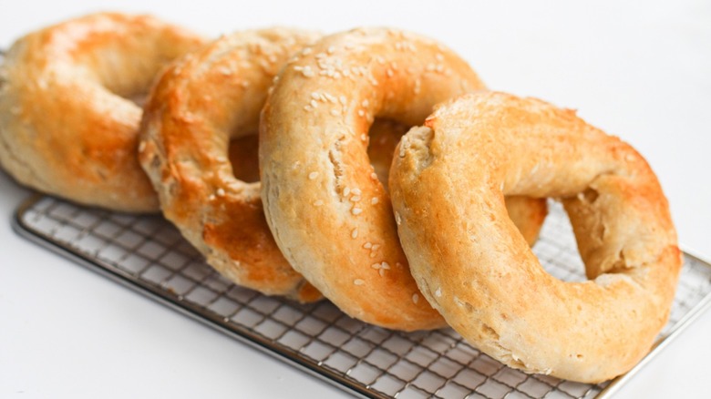 Freshly baked bagels on a serving tray.