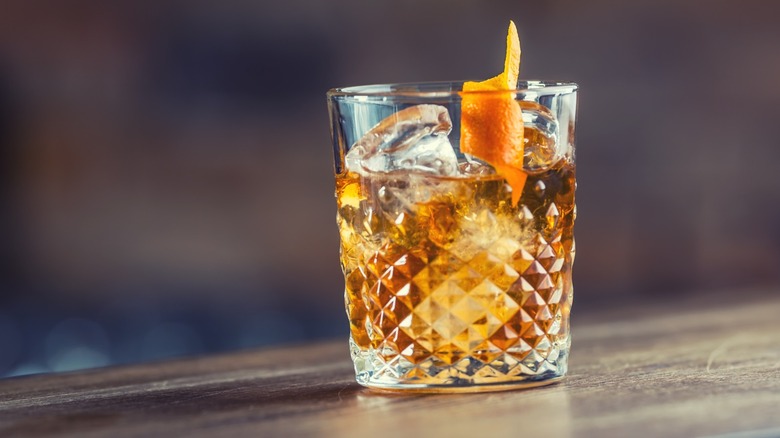Whiskey cocktail on the rocks with a twist