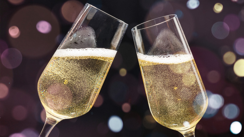 Two glasses of sparkling wine clinking