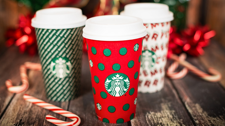 Three Starbucks drinks in holiday cups