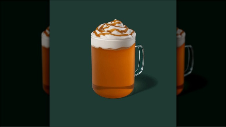cup of amber liquid with whipped cream on top