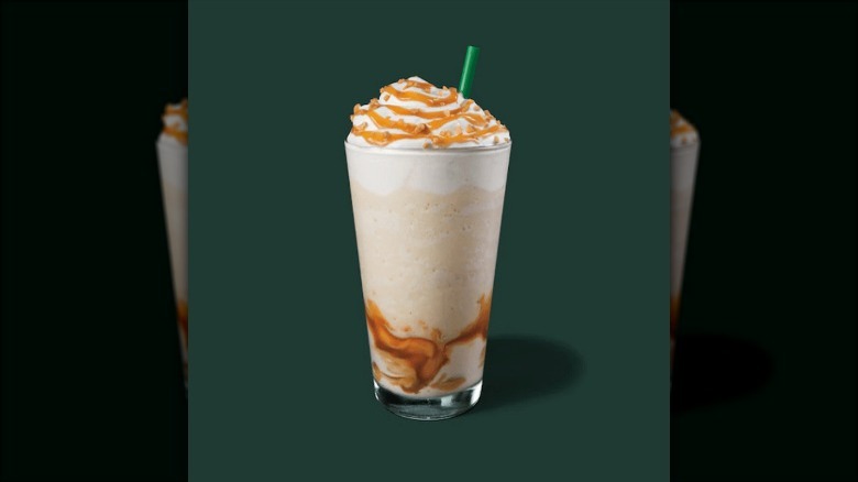 Frappuccino with caramel drizzle on green background