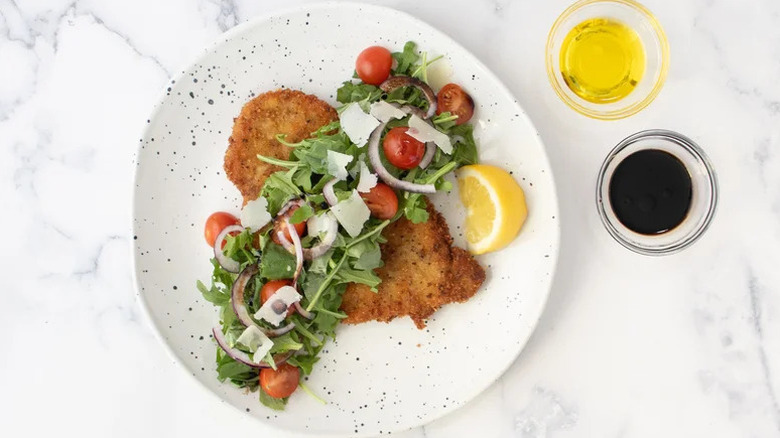 veal milanese plated with salad