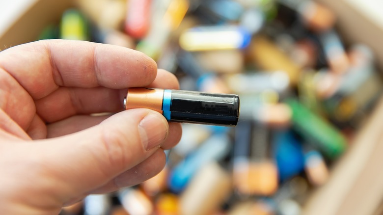 Hand holding battery