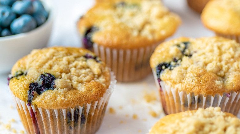 Baked blueberry muffins in paper liners. 
