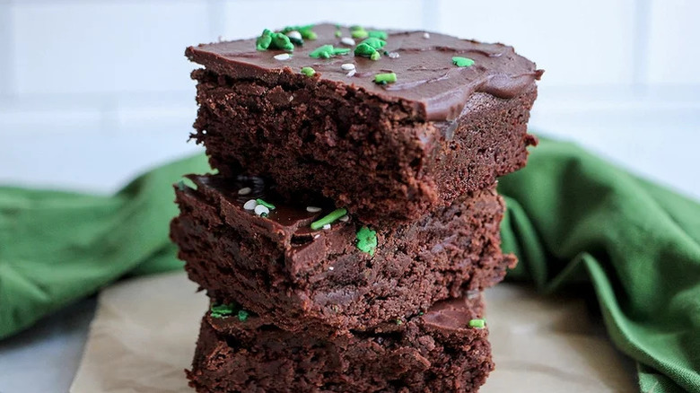 three Guinness brownies squares stacked on top of each other with sprinkles