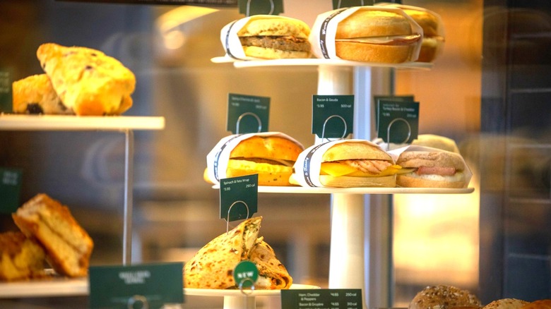 A display case of Starbucks breakfast sandwiches