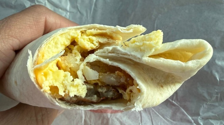 Hand holding Burger King Breakfast Burrito Jr