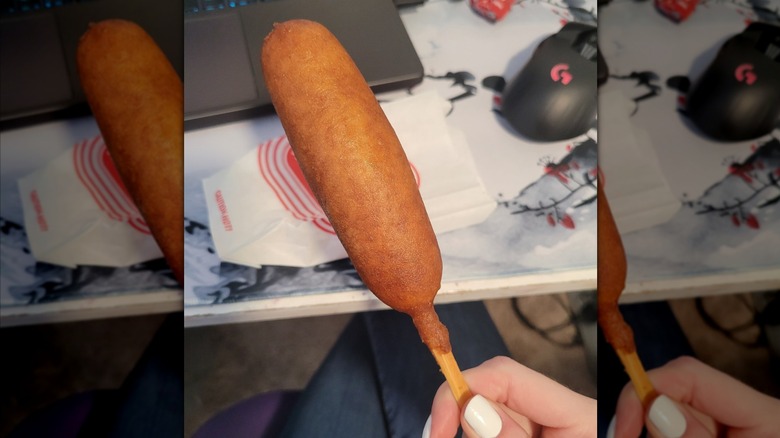 hand holding corn dog from Wienerschnitzel