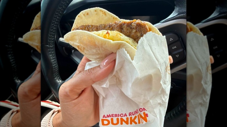 hand holding Dunkin Wake Up Wrap