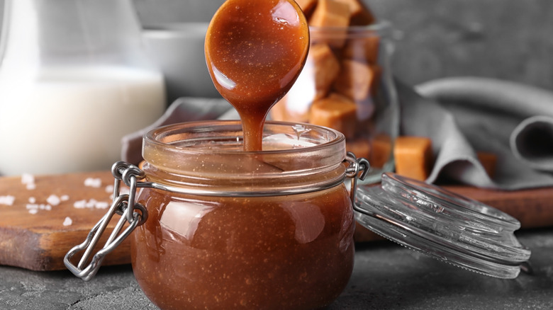 caramel sauce pouring off spoon