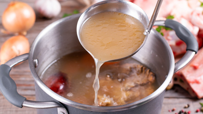 ladling pot of chicken stock