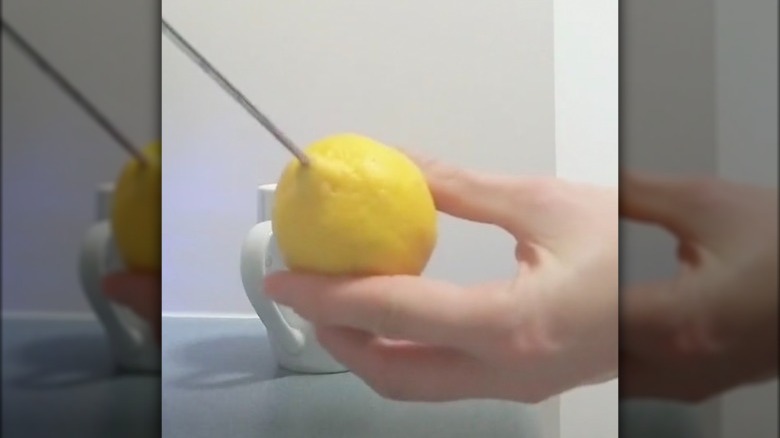 poking skewer in a lemon