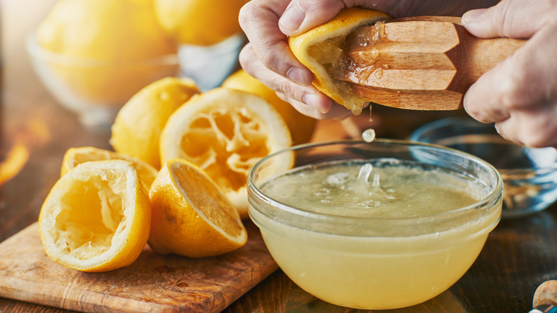 squeezing lemon juice in a bowl