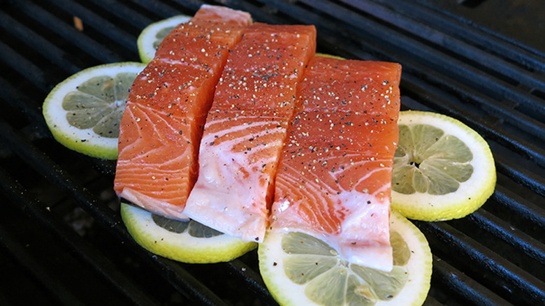 salmon over lemon slices on grill