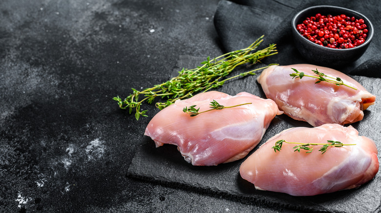 Raw chicken thighs with herbs