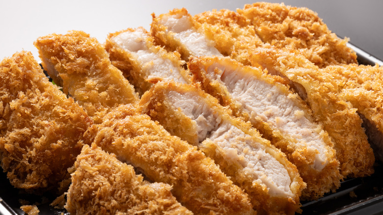 Slices of pork cutlets in a shallow steel basket
