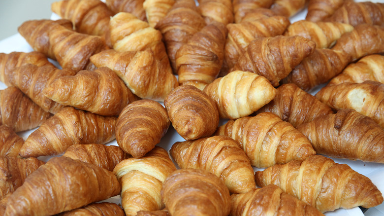 Croissants arranged nicely on a white cloth
