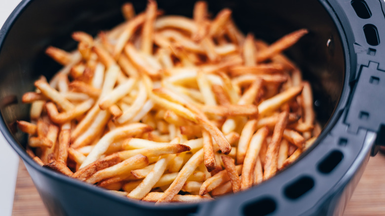 Browned French fries inside an air fryer