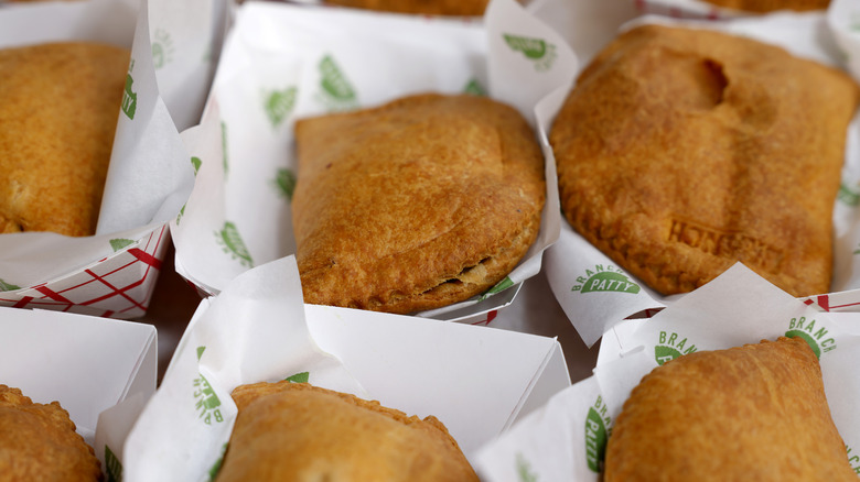 Jamaican patties individually placed in disposable cardboard plates