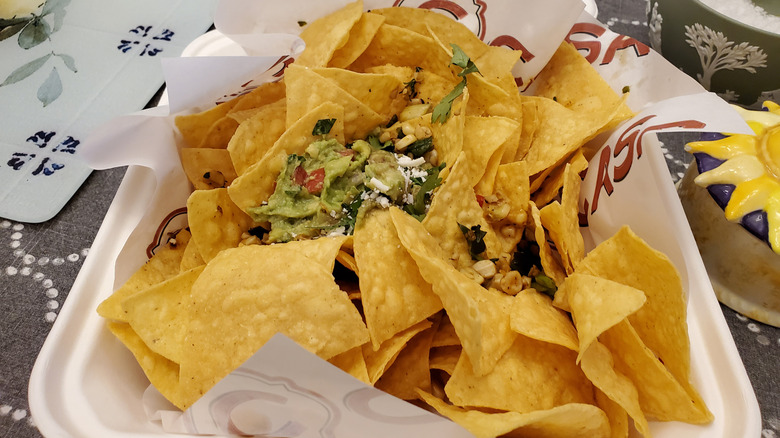 Nacho chips in a takeout container