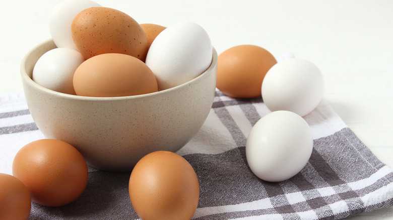 A bowl of white and brown eggs