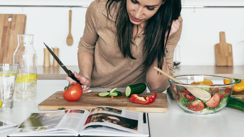 Woman reading cookbook