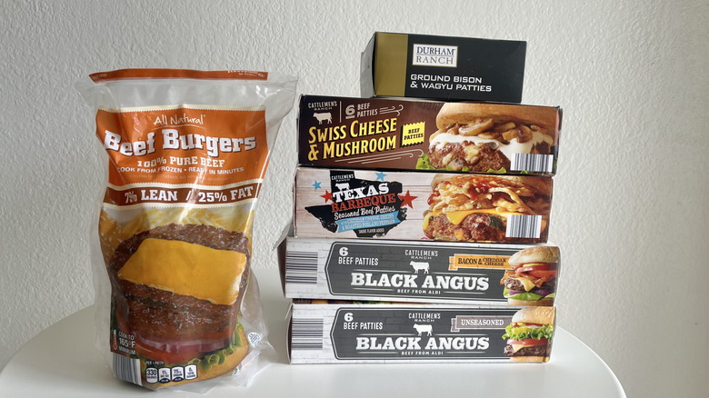 six types of burger packages on a small white table