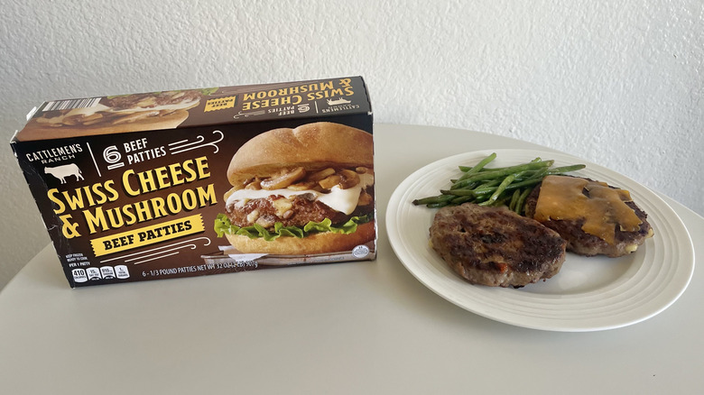 swiss mushroom beef patties on a small white plate