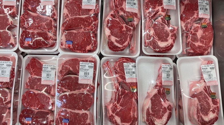 Steaks on display in a refrigerated case at Costco.