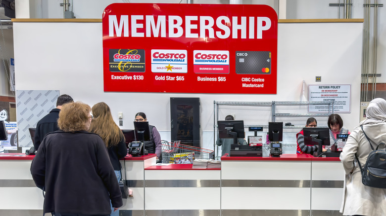 Shoppers standing in front of the Membership desk at Costco.