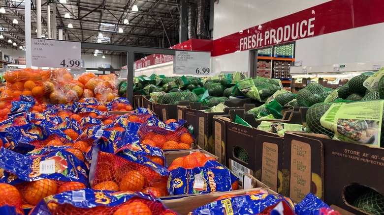 Inside the Costco produce department with bags of fruit and vegetables.