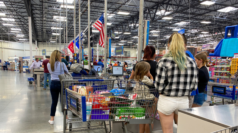 Shoppers waiting in line inside a Sam's Club location.