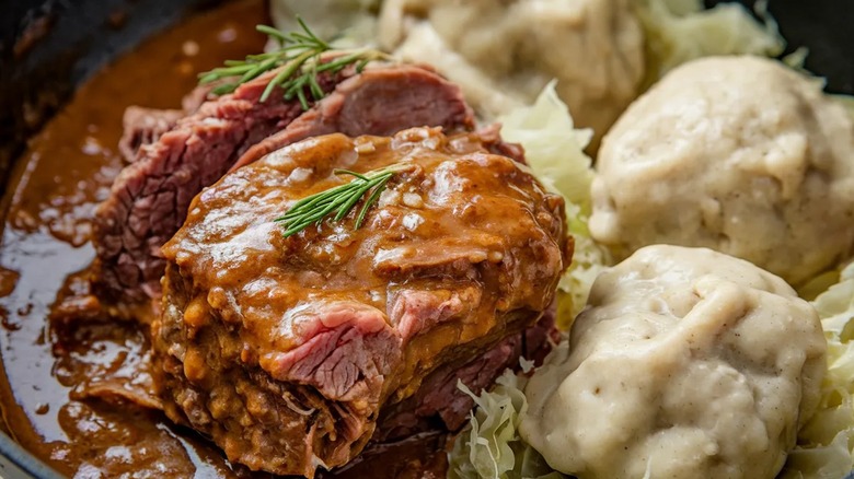 Braised meat over cabbage with dumplings