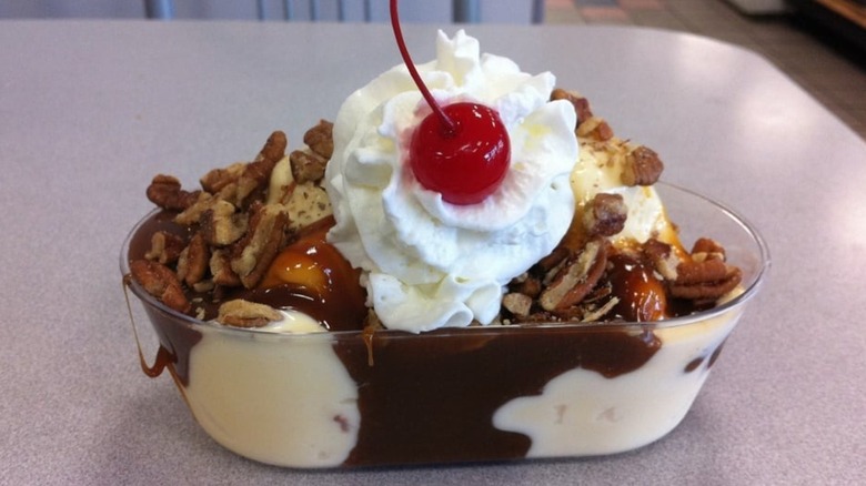 Braum's ice cream sundae with pecans, whipped cream, and cherry on top