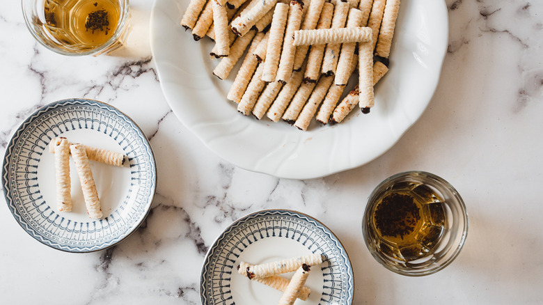 cookies on plates with two tea cups