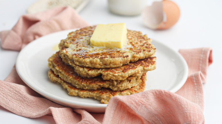 Stack of oatmeal pancakes with butter pat on top