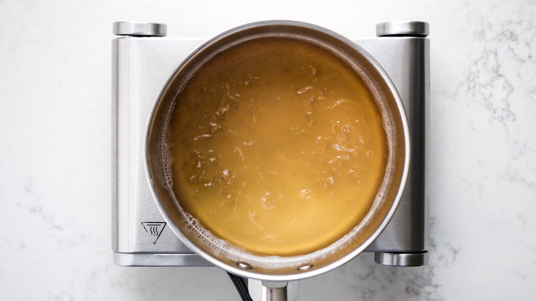 yellow liquid in metal pot