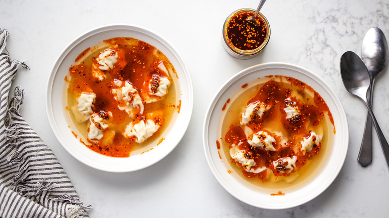 dumpling soup in white bowls
