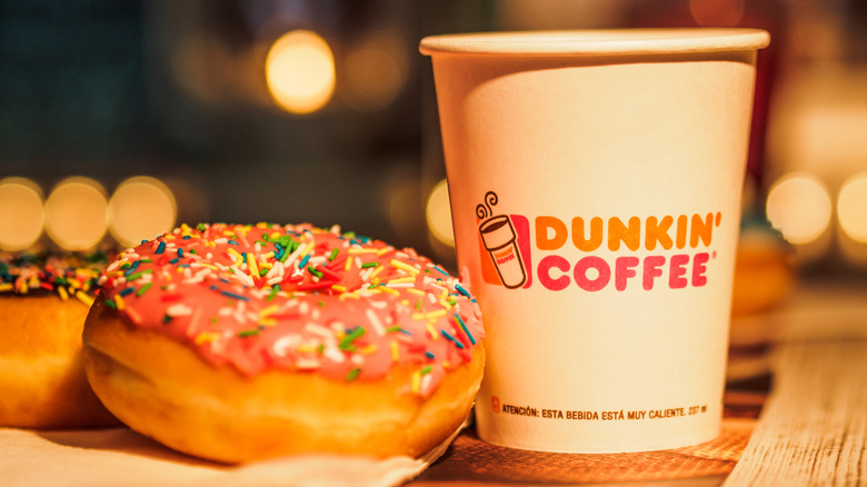 A small Dunkin' coffee with a sprinkle donut