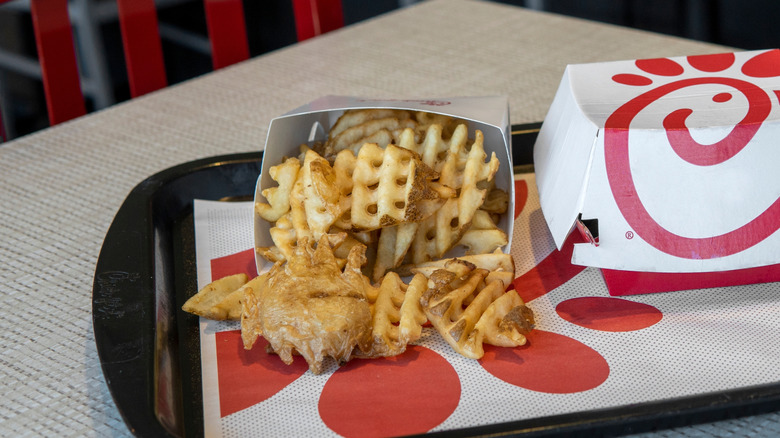 Chick-fil-A tray with carton of waffle fries and sandwich box.