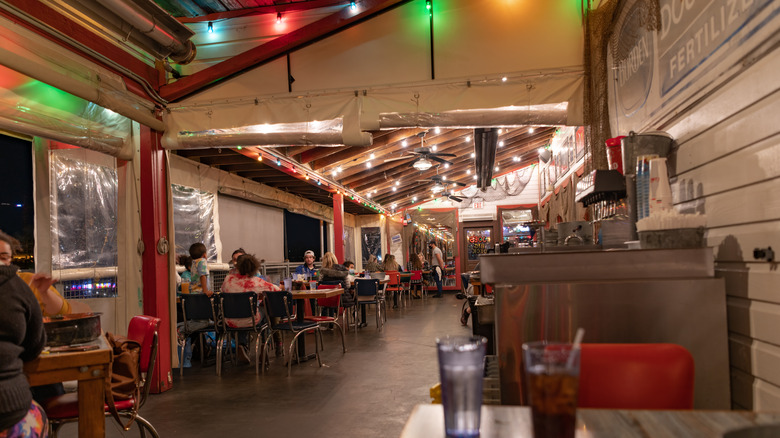 Interior of Joe's Crab Shack at night with string lights