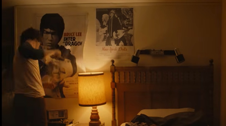 "Tony" scene showing Dominic Sessa as Anthony Bourdain punching bedroom wall.
