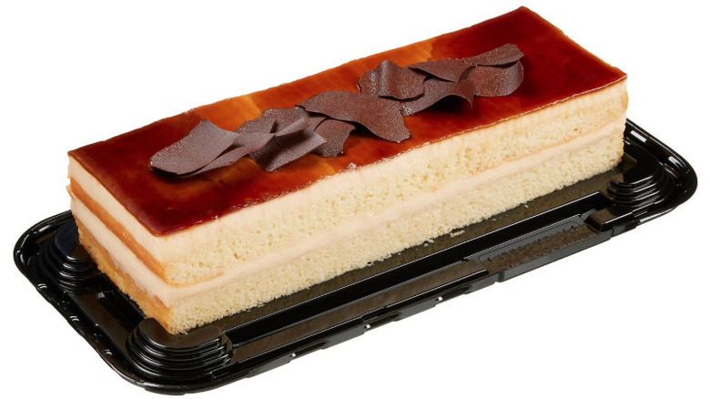 A tres leches-flavored bar cake on plastic serving tray.