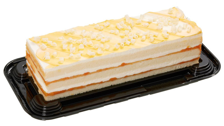 Peaches and cream-flavored bar cake on plastic serving tray.